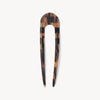 Brown tan tonal checkered hair pin on white background.