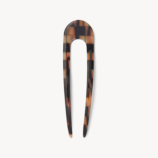 Brown tan tonal checkered hair pin on white background.
