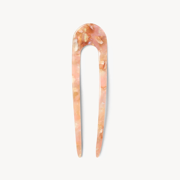 Marbled pink and beige hair pick on a white background