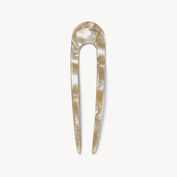 Iridescent beige hair pin on a white background