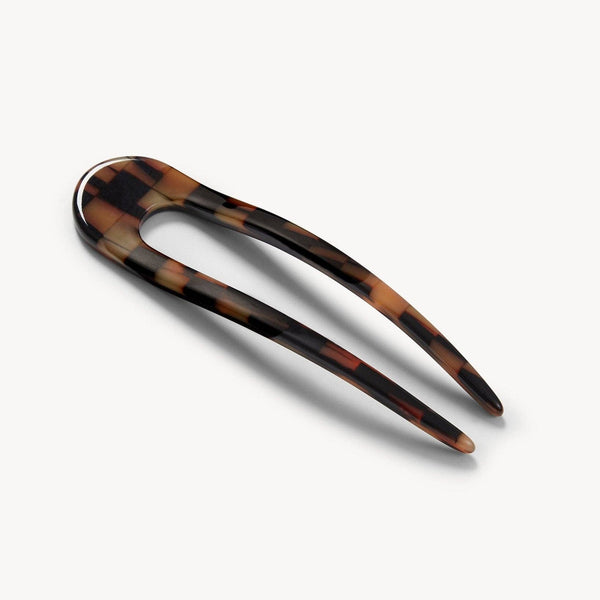Brown and tan tonal checkered hair pin on a white background