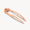 Marbled pink and beige hairpin on a white background