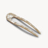Decorative hairpin with a natural finish on a white background