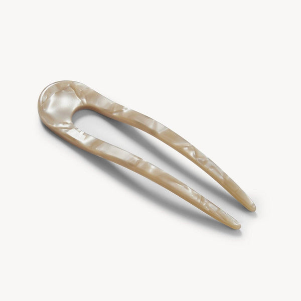 Decorative hairpin with a natural finish on a white background