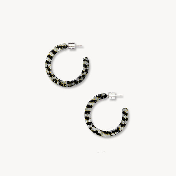 Black and translucent white hoop earrings on a white background