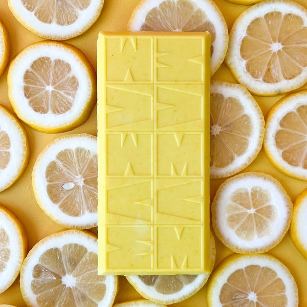 Yellow chocolate bar with 'M&M's' branding surrounded by lemon slices on a yellow background