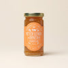 Jar of Meyer Lemon Honey Marmalade with a gold lid on a beige background