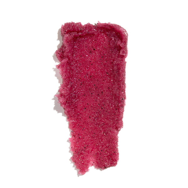 Pink hibiscus body polish smeared on white background.