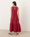 Woman wearing a red dress with a plain background