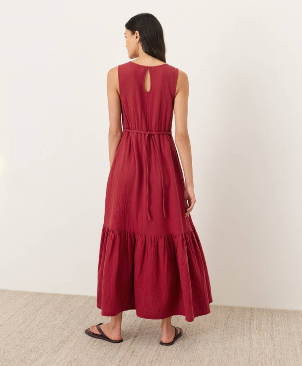 Woman wearing a red dress with a plain background