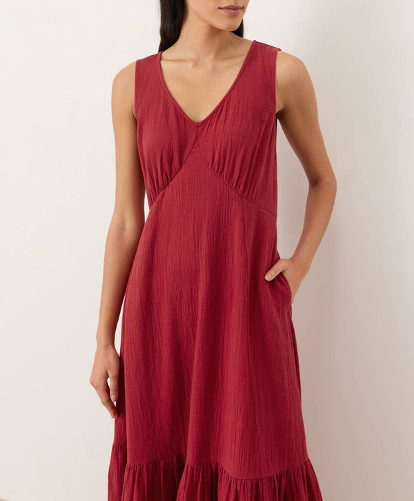 Red dress worn by a person on a plain background