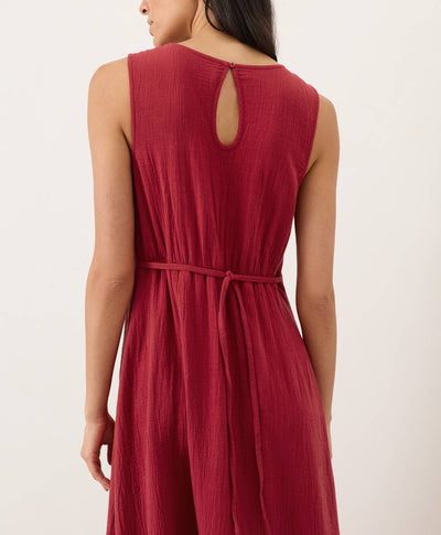 Red keyhole dress with a tie back belt on a plain background