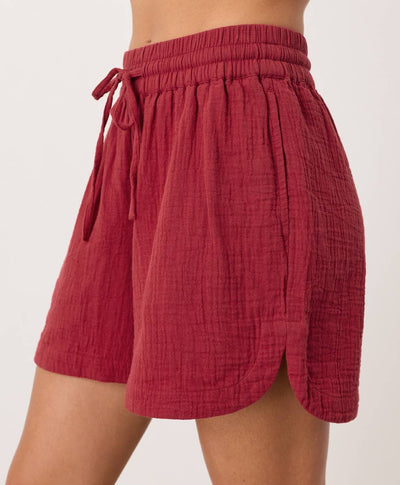Red shorts with a tie waist on a white background
