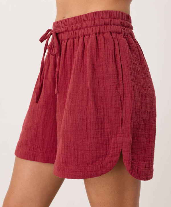 Red shorts with a tie waist on a white background
