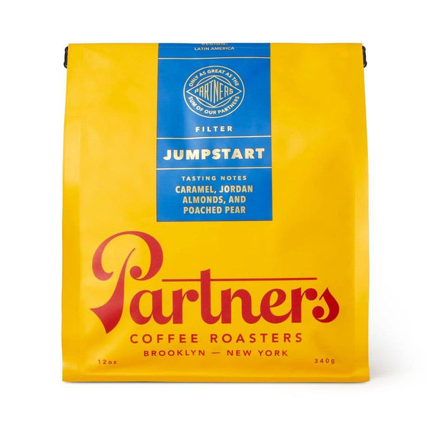 Yellow coffee bag with blue 'jumpstart' label featuring 'Partners Coffee Roasters' branding on a white background.