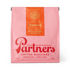 Pink coffee bag with orange 'elevate' label featuring 'Partners Coffee Roasters' branding on a white background