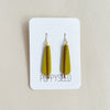 Chartreuse earrings with gold brass on a white card with 'Poppyseed' branding against a beige background