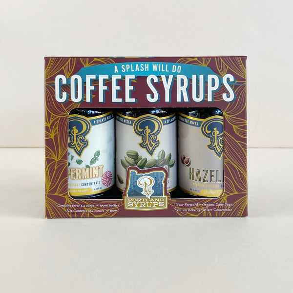 Packaging of Portland Syrups with three bottles inside on a white background