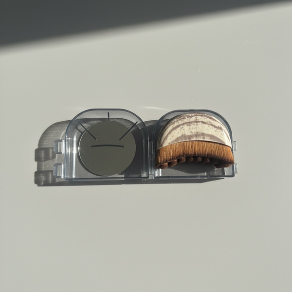 Lymphatic support facial dry brush with a clear case on a light gray background