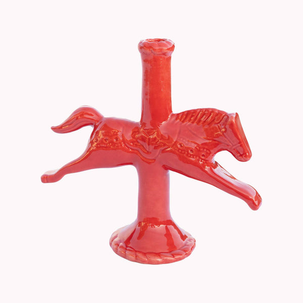 Red ceramic horse-shaped candle holder on a white background