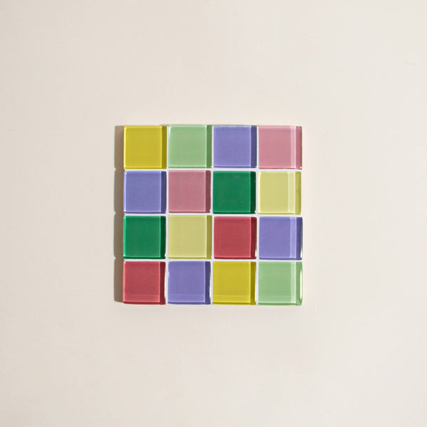 Square tile with colorful square pattern on a beige background