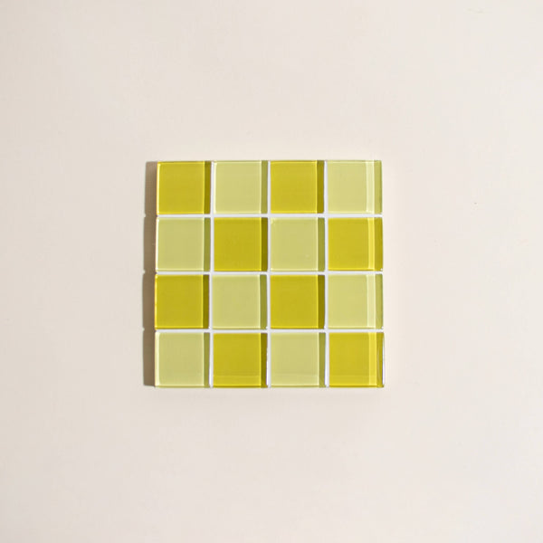 Square tile with two toned yellow grid pattern on a beige background