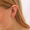 Close-up of person wearing a gold earring.