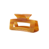 Honey colored hair claw clip on a white background