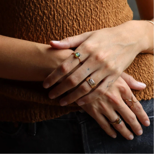 Close-up of hands with rings against a blurred background