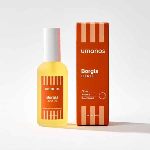 Bottle and box of umanos Borgia Body Oil on a white background