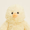 Plush toy chick on a light beige background