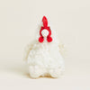 White and red plush chicken toy on white background.