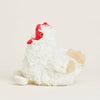 Plush toy chicken with a red head on a light beige background