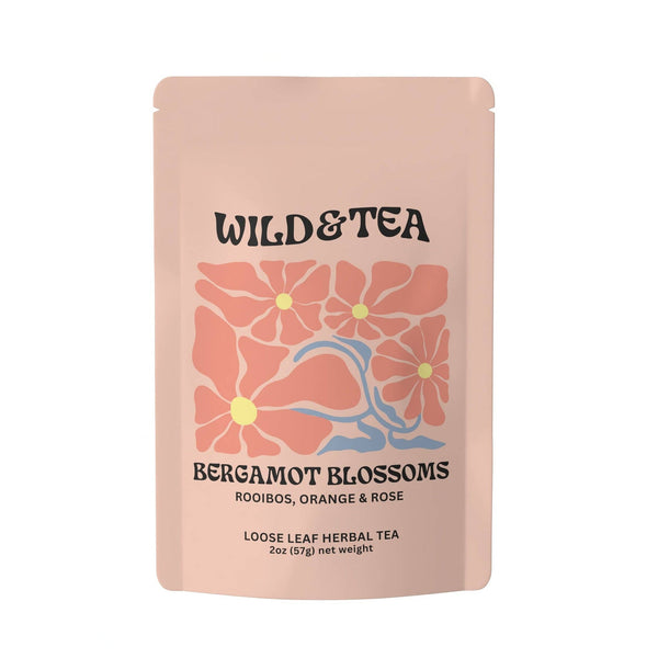 Pink tea package with floral design and 'Wild & Tea' branding on a white background