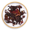 Dried hibiscus flowers on a white plate with a gold rim