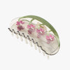 Hair claw with pink bleeding heart floral designs on a white background