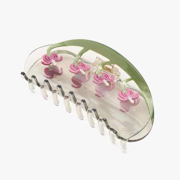 Hair claw with pink bleeding heart floral designs on a white background