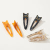 Three sets of cat-shaped hair clips in various neutral colors on a white background
