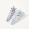 Two light blue cat-shaped hair clips with gold accents on a white background