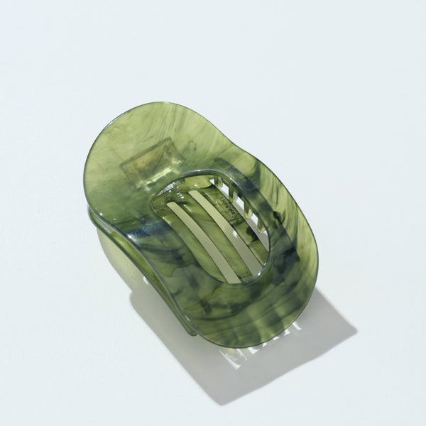 A translucent jade green oval hair claw clip with a marbled pattern, shown on a clean white background with a soft shadow.