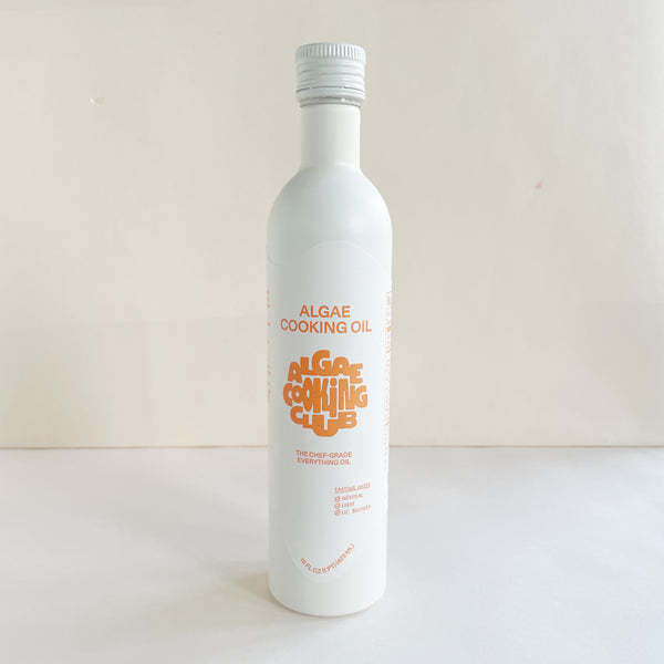 A white bottle labeled 'Algae Cooking Oil' with orange and black text, indicating the product is a cooking oil made from algae.