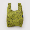 A small nylon shopping back in chartreuse with black paisley print on a white backdrop.