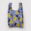 A small nylon shopping bag in a light purple color with a stylized design of golden yellow pears with dark leaves and star shaped accents on a white backdrop.