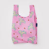 A small nylon shopping bag in pink with yellow and blue lambs and dainty red flowers against a white backdrop.