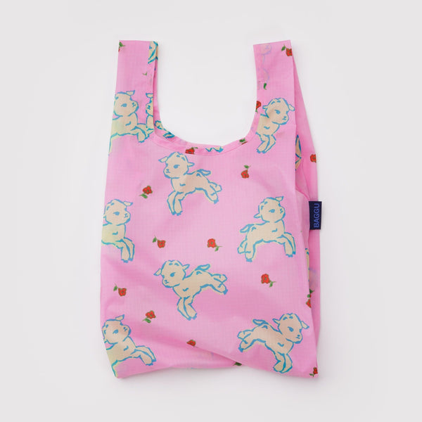 A small nylon shopping bag in pink with yellow and blue lambs and dainty red flowers against a white backdrop.