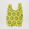 A small nylon shopping bag in bright yellow with black smiley faces against a white backdrop.
