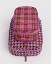 A pink and purple travel packing cubes set featuring a smaller zippered pouch on top of a larger houndstooth cube, photographed on a light gray background.