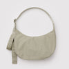 Celedon green nylon crescent crossbody bag against a white background.