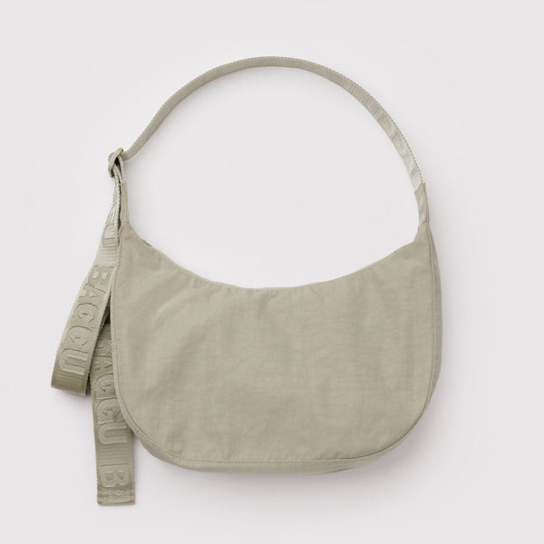 Celedon green nylon crescent crossbody bag against a white background.