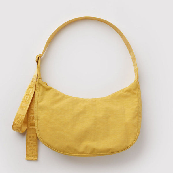 A sunflower yellow nylon crescent crossbody bag against a white background.